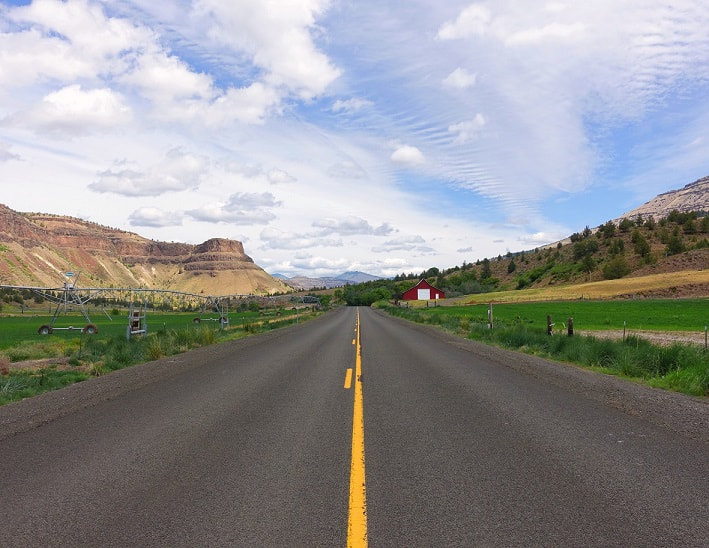 Summer Drive with a red barn on Highway 19 in the Sheep Rock Unit of the John Day Fossil Beds