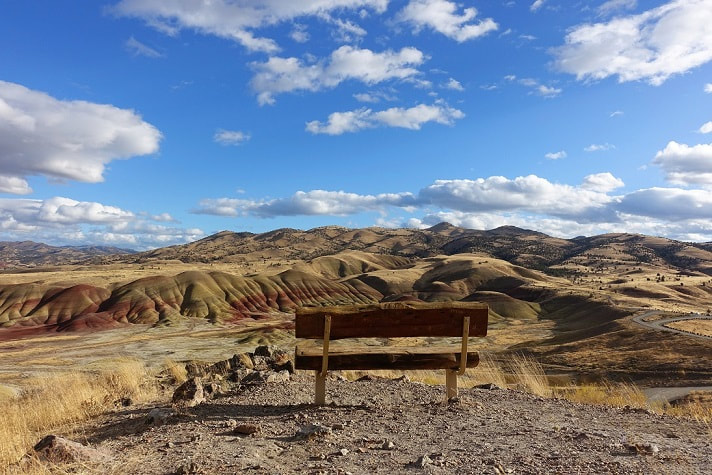Panoramic view of the Painted Hills from Carroll Rim Trail with an empty bench, John Day Fossil Beds