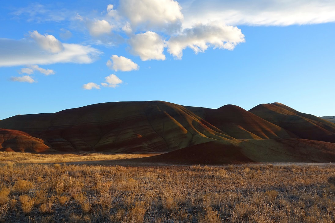 Photograph at golden hour at the entrance to the Painted Hills in the fall. Mitchell, Oregon, John Day Fossil Beds National Monument